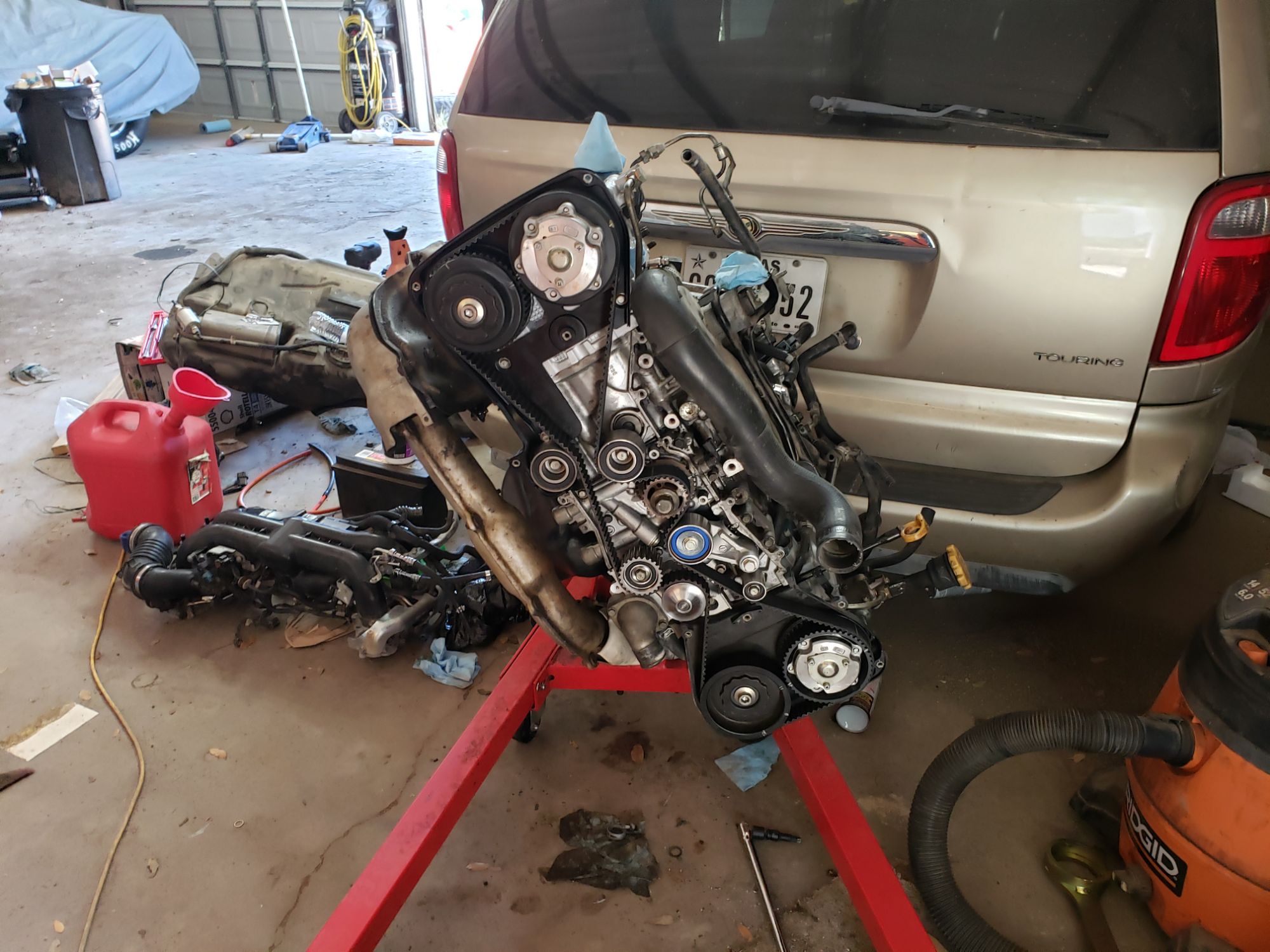 Automotive engine rebuild in progress at Alto Automotive in Alto, New Mexico, showing factory-spec torque assembly on engine stand.
